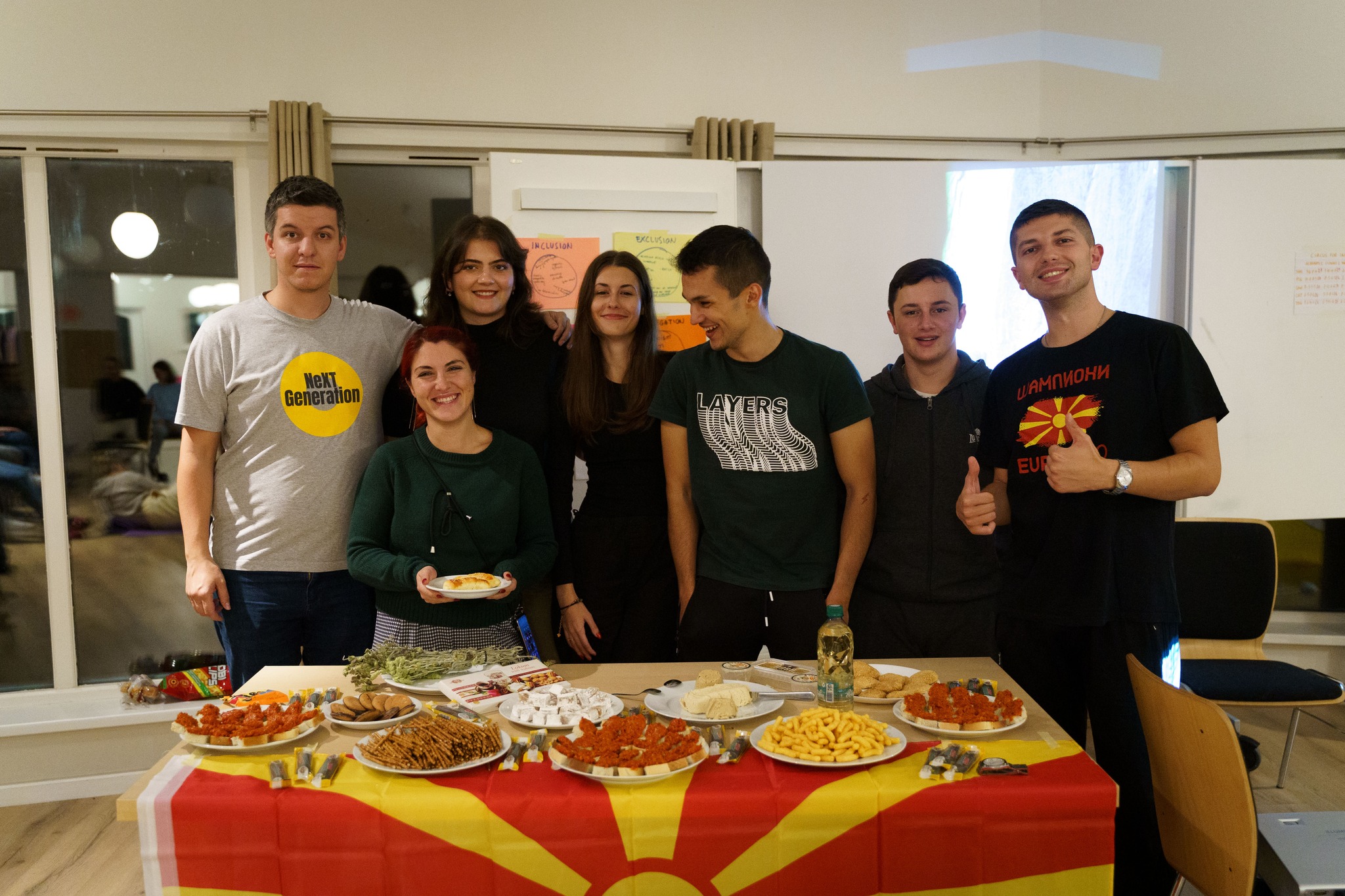 A group of people in presenting Macedonian food